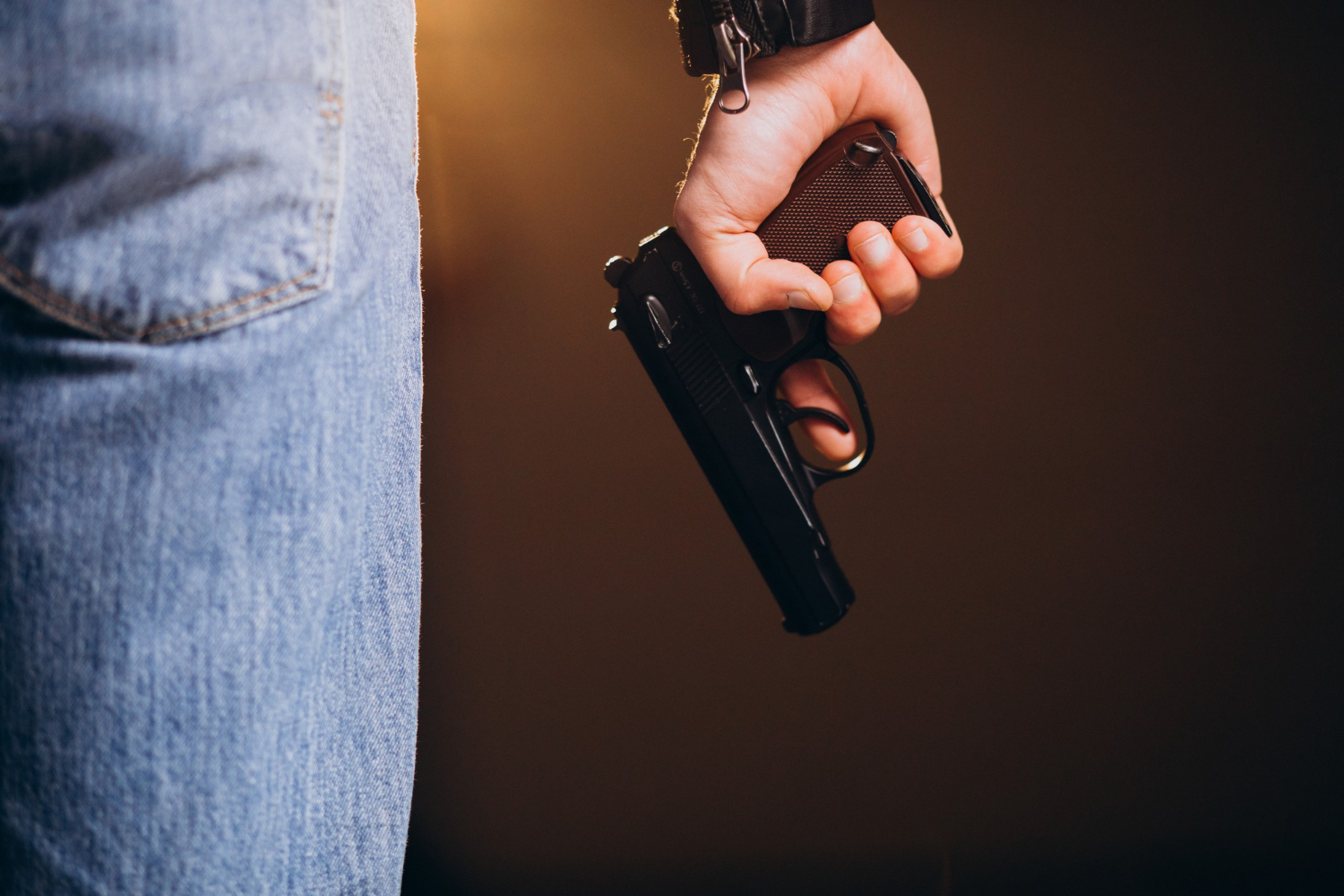 handsome man actor posing studio with weapon